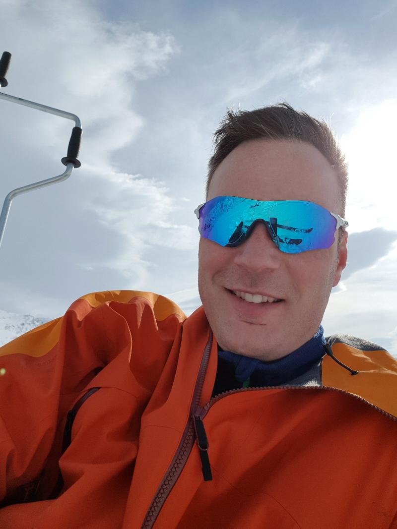 en mann med solbriller i vinterlandskap